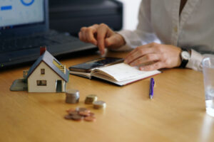 A person pointing a booklet on table - how much house can I afford